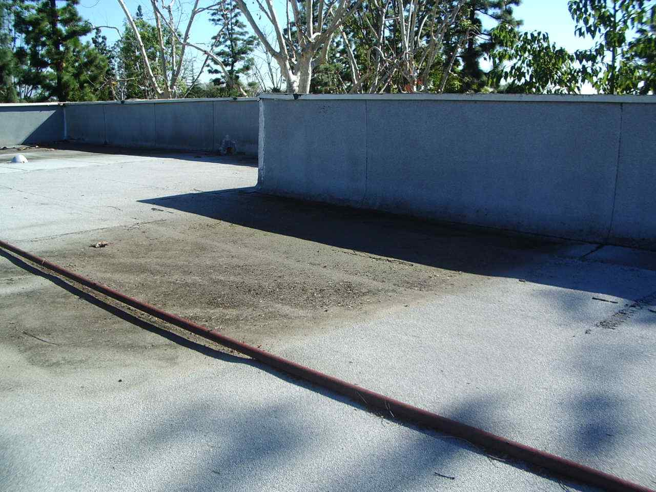 Why Did My Flat Roof Develop Low Spots? - RoofSlope